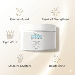 A white jar labeled Silk Touch System Mask is shown with icons and text emphasizing that it repairs, strengthens, fights frizz, smooths, softens, and adds shine.