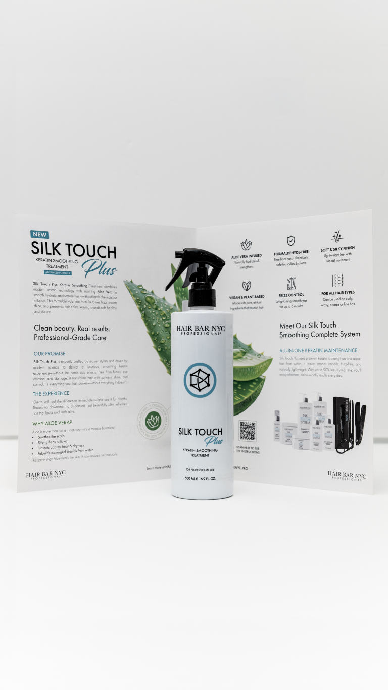 A bottle of Silk Touch Plus Keratin is positioned in front of an open brochure that showcases its product information and benefits.