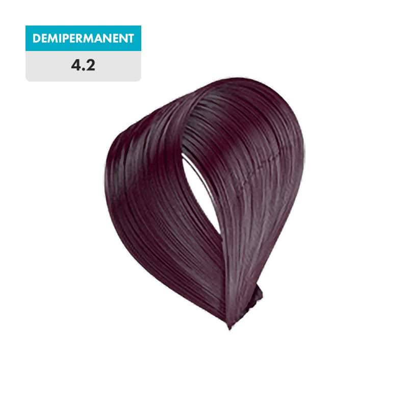 A swatch of 4.2 - Medium Violet Brown (Demipermanent) hair dye, a rich medium violet brown shade, is displayed against a green background.