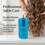 A blue bottle of Ultimate Repair System Curl Cream sits on a counter beside someone with long, wavy hair, highlighting professional salon care for smooth, defined curls.