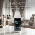 A bottle of Blond Plex Violet Developer 30 Volume rests on a marble counter in a modern, well-lit hair salon.