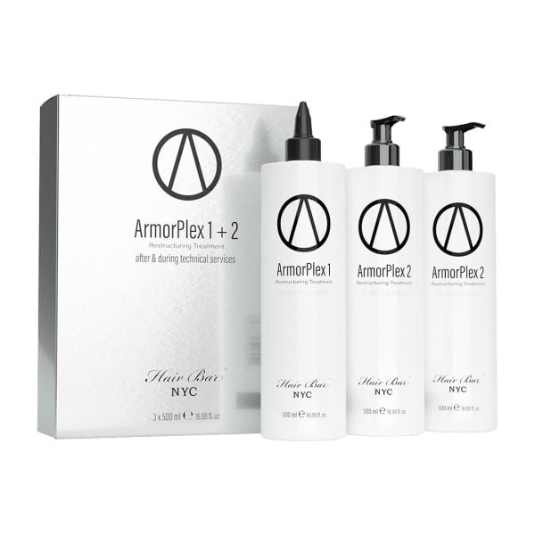 Three white bottles labeled ArmorPlex Restructuring Treatment stand beside a matching Hair Bar NYC box, created to complement diamond botox hair therapies.
