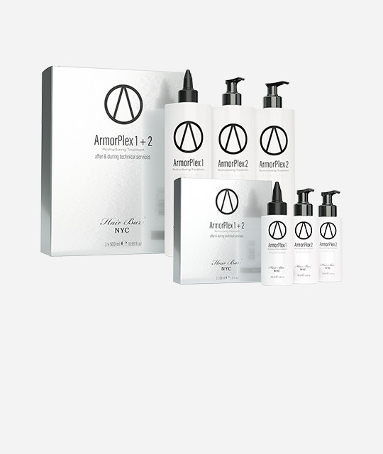 A set of ArmorPlex 1 and 2 hair care products, including bottles with pumps and pointed caps, displayed alongside their packaging boxes on a plain background.