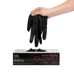 A hand pulls a black glove from a box labeled "Black Deluxe Vinyl Gloves - Powder Free, 100 per box, Medium," highlighting these professional-ready gloves.