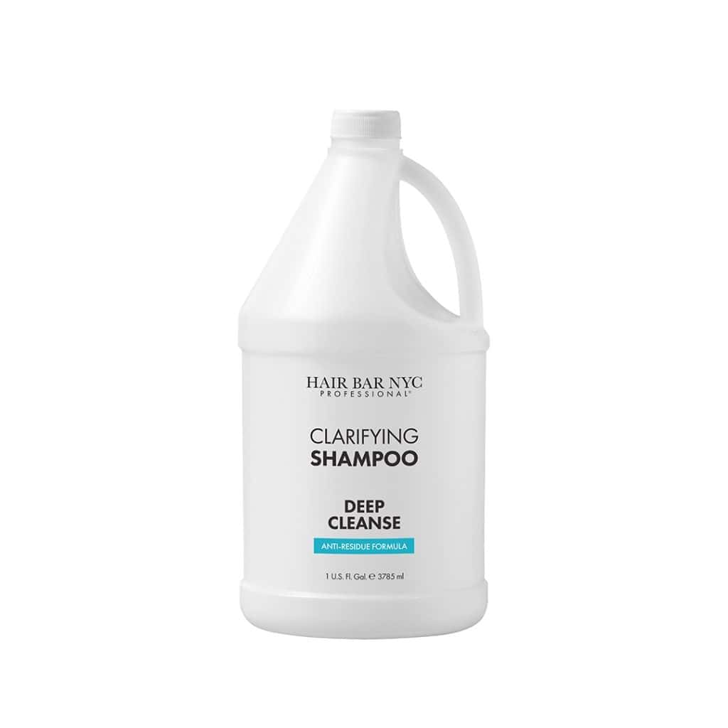 A large white gallon bottle labeled "Clarifying Shampoo Gallon" with a handle and a white cap.