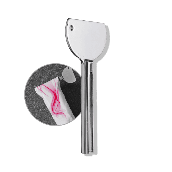 A large silver Color Tube Squeezer with a round handle is shown cutting open a white plastic package with pink lines.