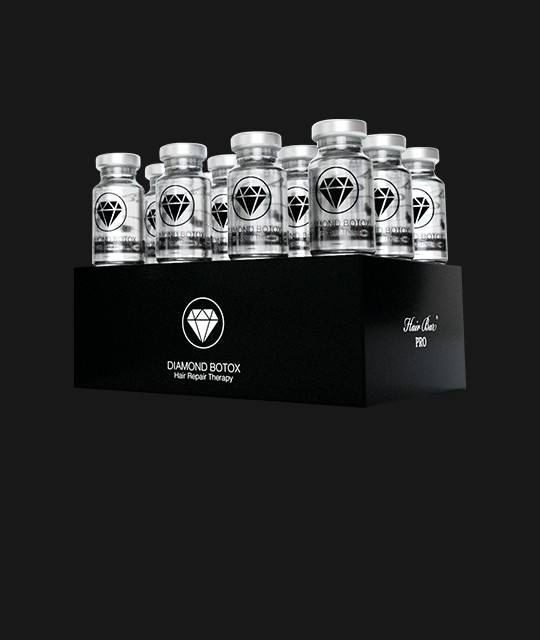 A black display box labeled "Diamond Botox Hair Repair Therapy" holds multiple clear vials with silver caps and diamond logos, arranged in two rows.