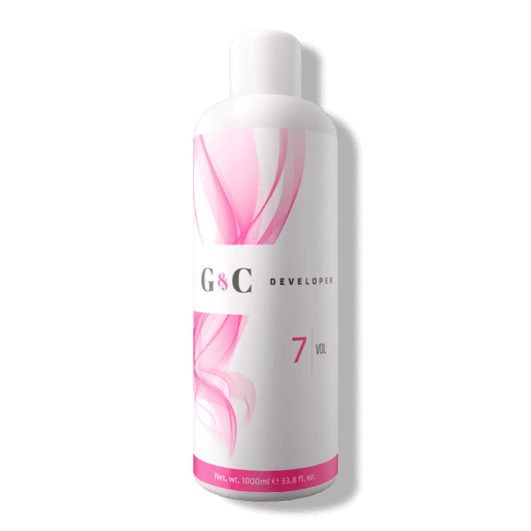 A 1000 ml white plastic bottle of G&C Cream Developer 7 Volume, featuring a pink abstract design, stands upright on a plain background.