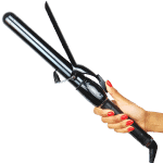 A hand with red-painted nails holds the Ultimate Pro Clip Curling Iron 1", its sleek black and silver body gleaming as the brand name stands out on the handle.