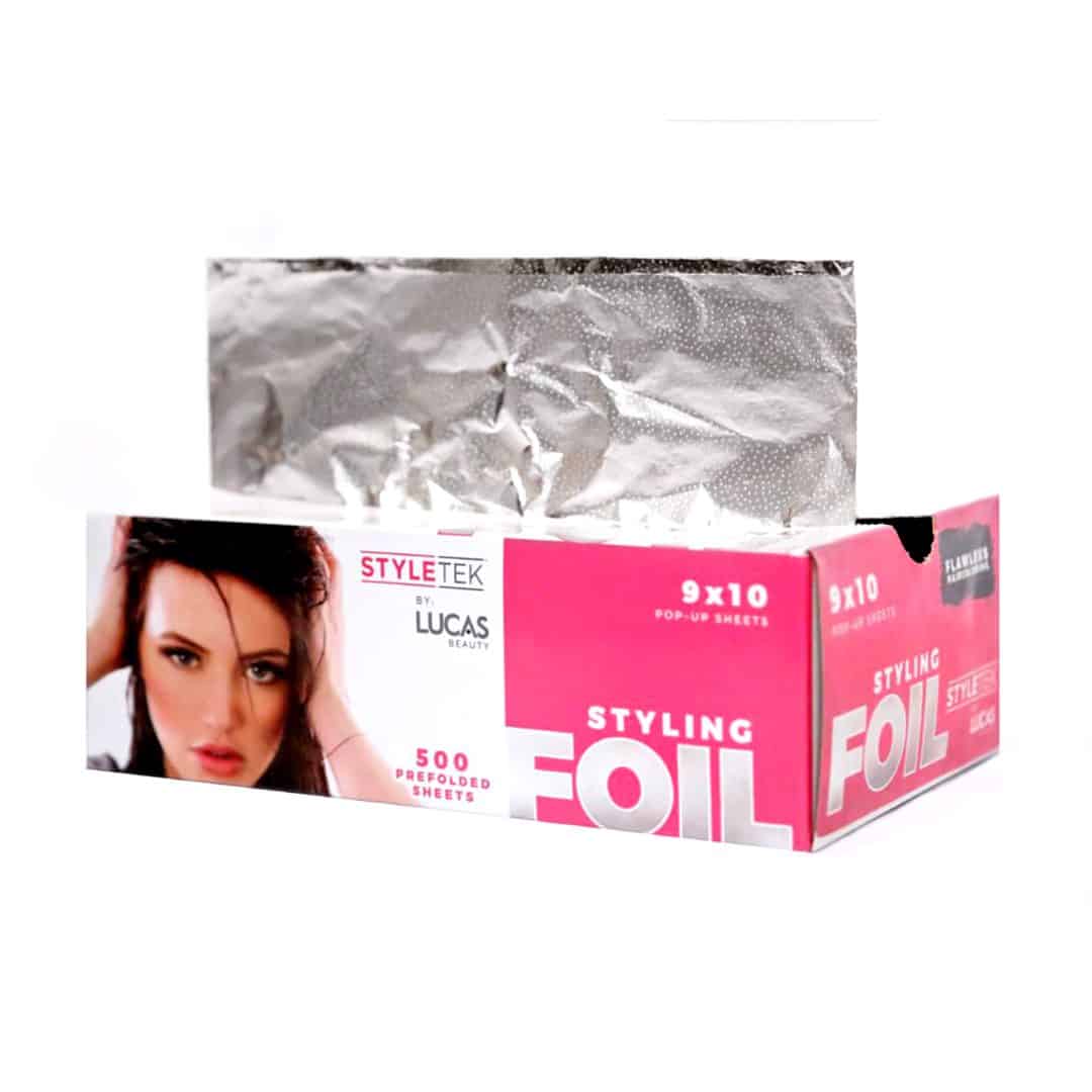 A pink and white "Pop Up Foil 9 x 11 – Heavy Emboss (500CT)" box with a woman's face dispenses 500 pre-folded, silver foil sheets, each measuring 9x11 inches.