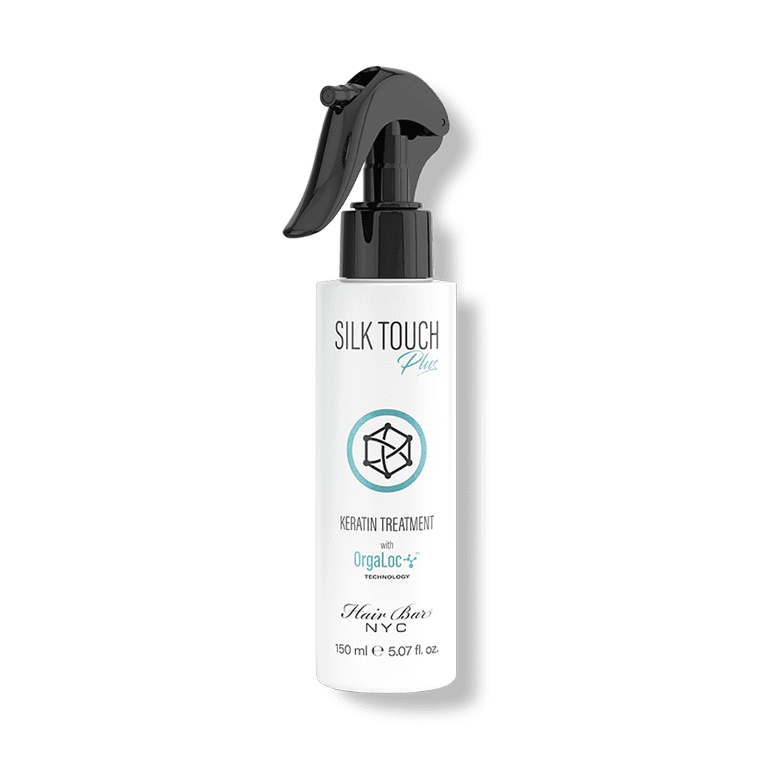 A white spray bottle labeled "Silk Touch Plus Keratin" by Hair Bar NYC, 150 ml (5.07 fl oz), features a black spray nozzle.