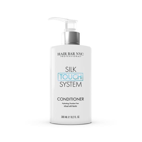 A 10.2 fl oz white bottle of Silk Touch System Conditioner by Hair Bar NYC Professional features a pump dispenser and detailed front label.
