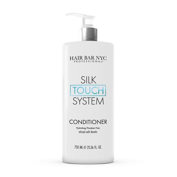 A 750 ml white bottle of Silk Touch System Conditioner with a pump, labeled hydrating, paraben free, and keratin-infused.