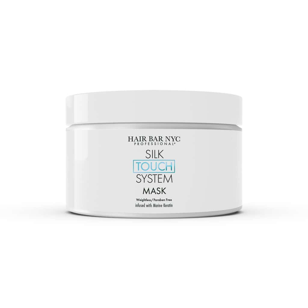 A white jar labeled "Hair Bar NYC Professional Silk Touch System Mask" pairs perfectly with the Silk Touch System Conditioner for smooth, revitalized hair.