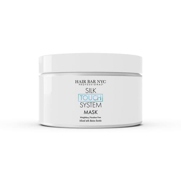 A white jar labeled "Hair Bar NYC Professional Silk Touch System Mask" pairs perfectly with the Silk Touch System Conditioner for smooth, revitalized hair.