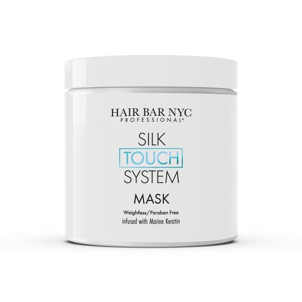 A white container labeled "Silk Touch System Conditioner," described as weightless, paraben-free, and infused with marine keratin—an ideal complement to the Silk Touch System Mask for smoother, healthier hair.