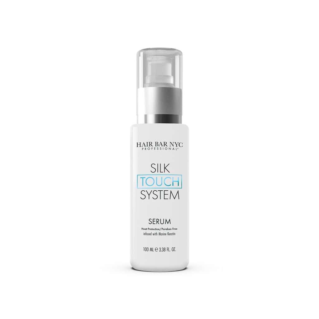 A 100 ml bottle of Hair Bar NYC Silk Touch System Serum with a pump sits next to a matching 100 ml Silk Touch System Conditioner.