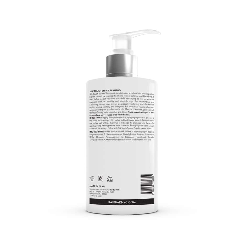 A white Silk Touch System Conditioner shampoo bottle with a pump dispenser is shown from the back, featuring black text on the label for product description, directions, ingredients, barcode, and website information.