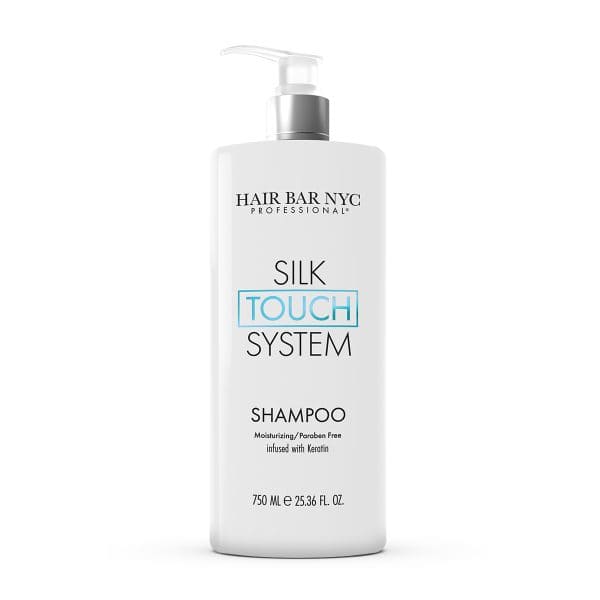 A white bottle of Hair Bar NYC Silk Touch System Conditioner, 750 ml, with a pump dispenser. Moisturizing, paraben-free, and keratin-infused. Complements the Silk Touch System Shampoo.