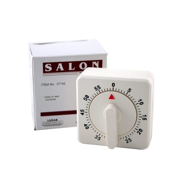 A square white Timer (60 Min) Alarm with Bell is set to 55 minutes and placed in front of its box, which is labeled "SALON" and lists the item number and features.