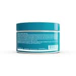 A turquoise and white cosmetic jar of Ultimate Repair System Conditioner is shown from the back, displaying its product description, directions, and ingredients in small text.