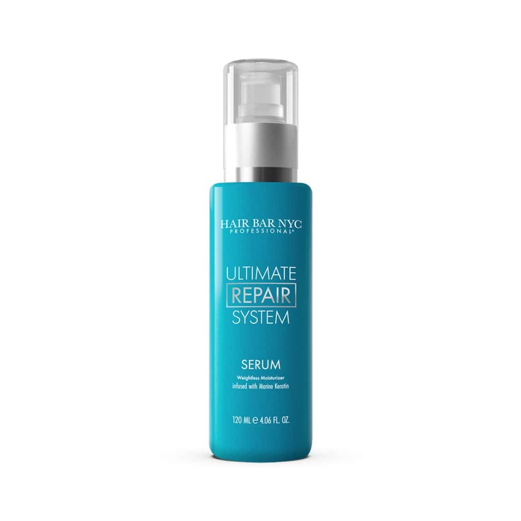 A 120 ml (4.06 fl. oz.) blue bottle of Ultimate Repair System Conditioner with a pump dispenser, ideal for use with the matching serum.