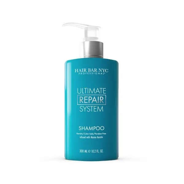 A blue pump bottle labeled "Hair Bar NYC Professional Ultimate Repair System Shampoo," 300 ml, with keratin and marine keratin, sulfate and paraben free—pairs perfectly with Ultimate Repair System Conditioner for complete hair restoration.