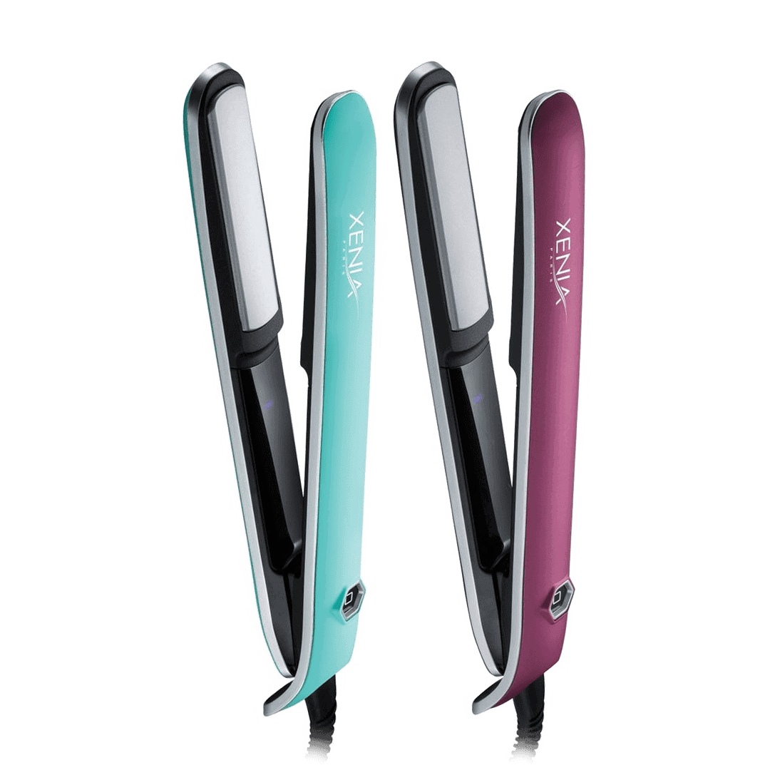 Two Xenia Sleek Flat Iron 1" hair straighteners, one teal and one maroon, stand upright side by side with their plates open and facing forward.