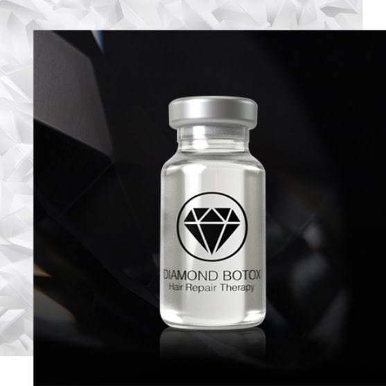 A clear vial labeled "Diamond Botox Hair Repair Therapy" with a diamond icon, set against a dark, geometric background.
