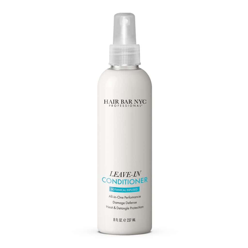 A white 8 fl oz spray bottle of Leave-in Conditioner, botanical infused, with product and dry shampoo details printed on the front.