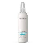 A white 8 fl oz spray bottle of Leave-in Conditioner, botanical infused, with product and dry shampoo details printed on the front.