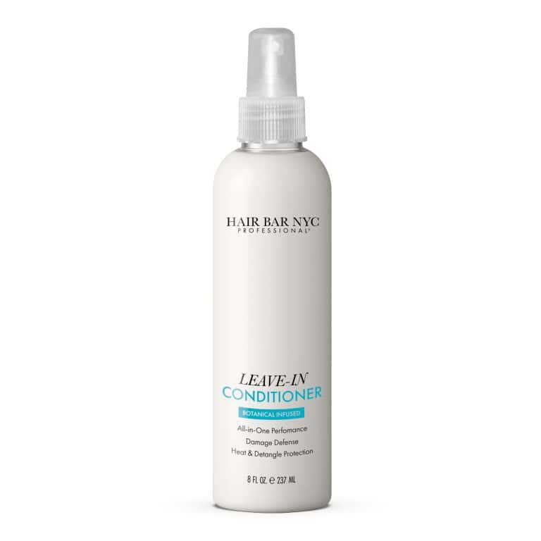 A white 8 fl oz spray bottle of Leave-in Conditioner, botanical infused, with product and dry shampoo details printed on the front.