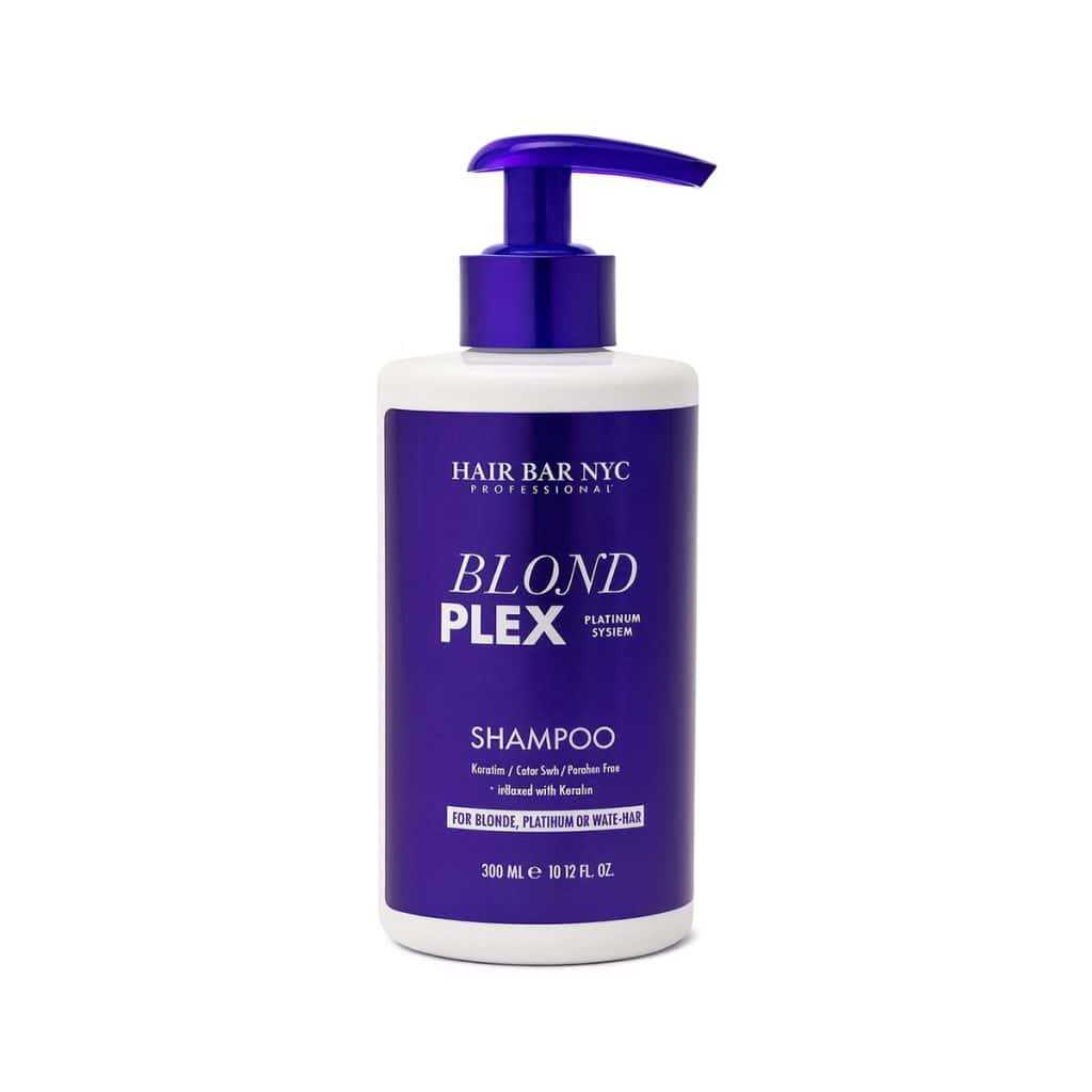 A bottle of Blond Plex Platinum System Shampoo, featuring a purple pump and label, formulated for blonde, platinum, or highlighted hair.