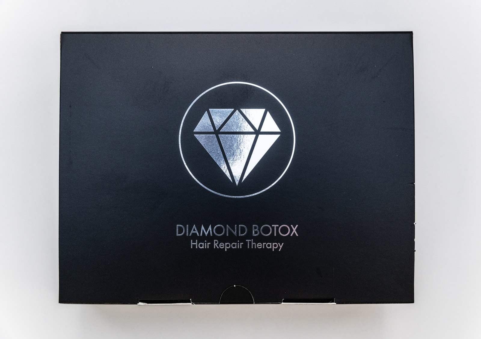 Black Diamond Botox box lid with silver diamond emblem